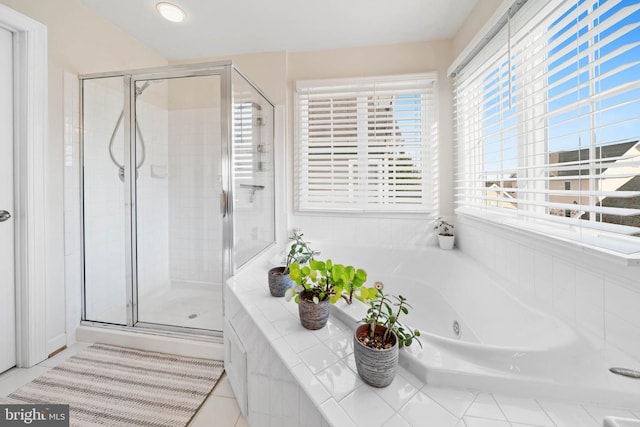 full bath with a shower stall and a jetted tub