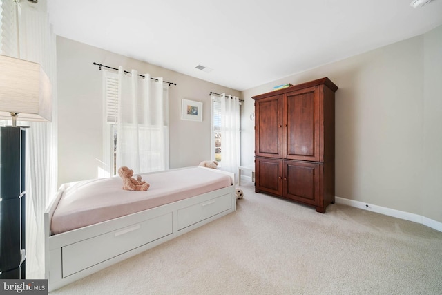 bedroom featuring visible vents, baseboards, and light colored carpet