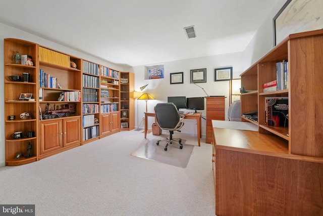 office area with visible vents and carpet