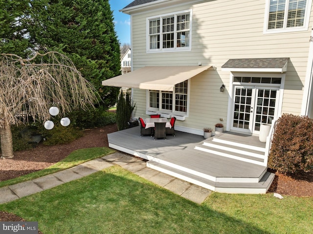 rear view of house with french doors, roof with shingles, and a deck