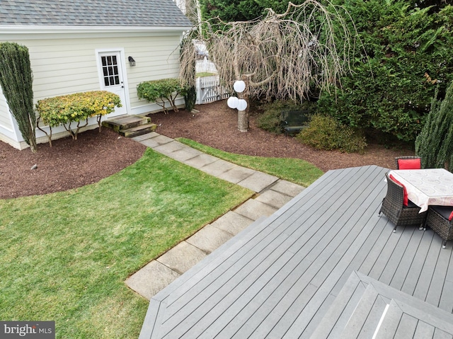 wooden deck with a lawn