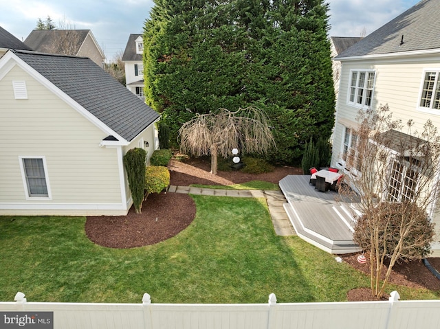 view of yard with a deck and fence