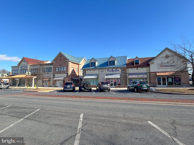 view of building exterior with uncovered parking