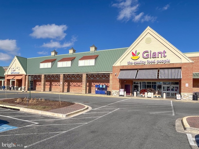 view of building exterior featuring uncovered parking