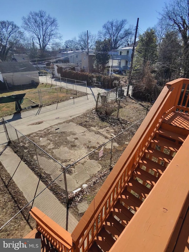 wooden terrace featuring stairs and fence