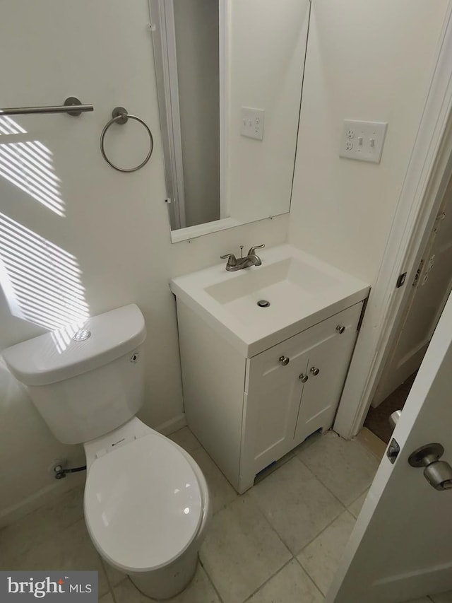 bathroom with tile patterned flooring, toilet, and vanity