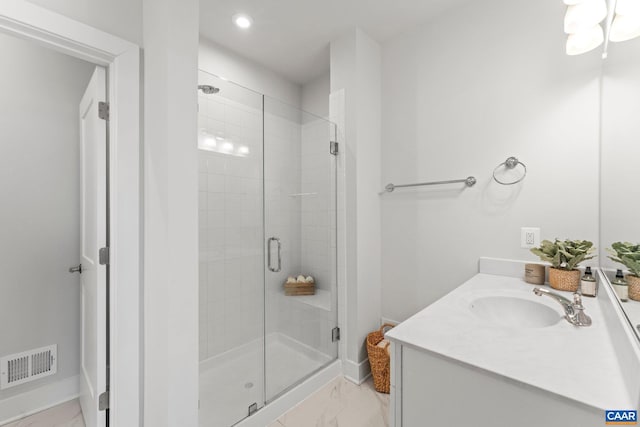 full bathroom featuring vanity, baseboards, visible vents, a shower stall, and marble finish floor