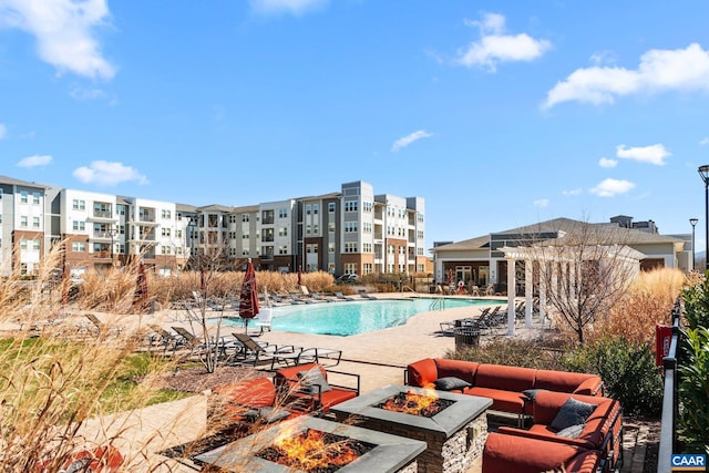 community pool with a patio area and a fire pit