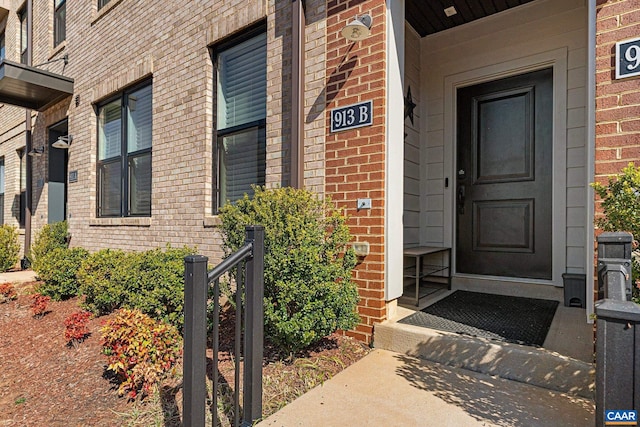 property entrance with brick siding