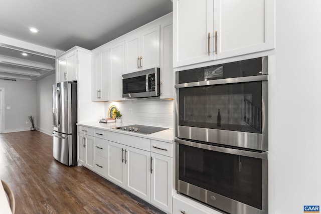 kitchen featuring dark wood-type flooring, backsplash, stainless steel appliances, white cabinets, and light countertops