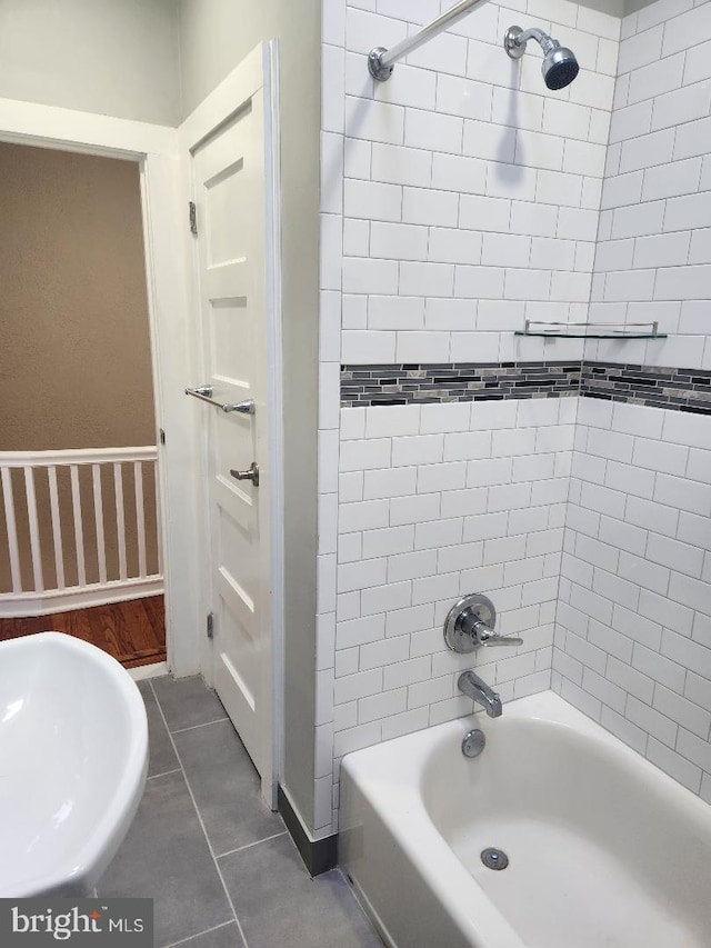 full bathroom featuring tile patterned flooring, wallpapered walls, baseboards, bathtub / shower combination, and a sink