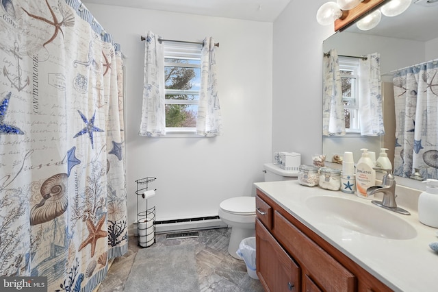 bathroom featuring baseboard heating, toilet, and vanity