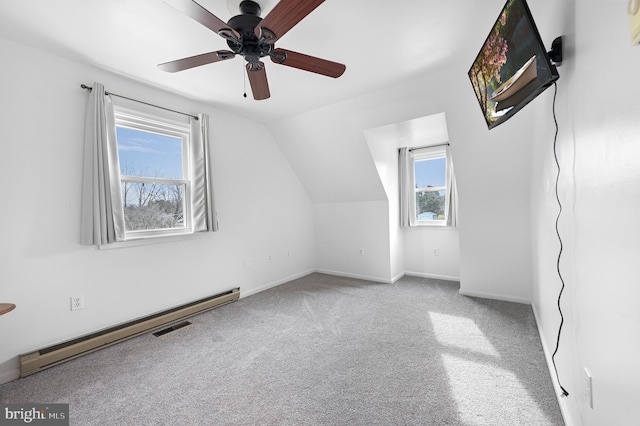 additional living space featuring carpet, visible vents, baseboards, a baseboard radiator, and vaulted ceiling