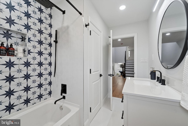 bathroom featuring vanity, recessed lighting, and shower / bathtub combination