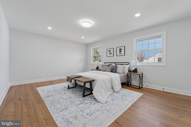 bedroom featuring recessed lighting, baseboards, and light wood-type flooring