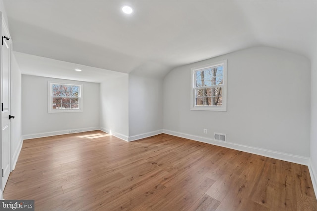 bonus room featuring light wood-style flooring, visible vents, and a wealth of natural light