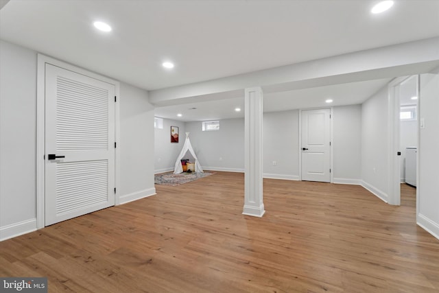 below grade area with recessed lighting, light wood-style floors, and baseboards