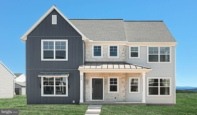 view of front of house featuring metal roof, stone siding, and a standing seam roof