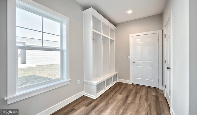 mudroom with dark wood-type flooring and baseboards