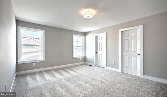 unfurnished bedroom featuring carpet flooring and baseboards