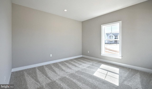 spare room with recessed lighting, baseboards, and carpet floors