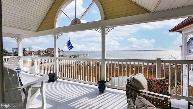 wooden deck featuring a water view