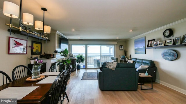 living area with recessed lighting, baseboards, wood finished floors, and crown molding