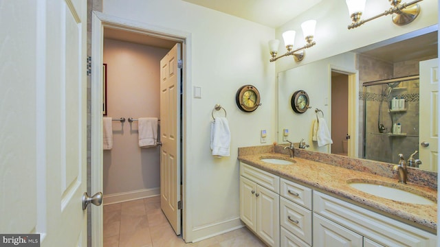 bathroom featuring double vanity, a shower stall, baseboards, and a sink