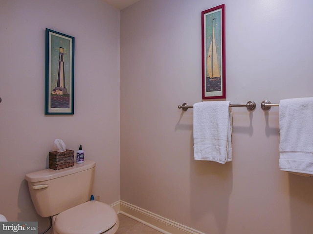 bathroom with toilet and baseboards