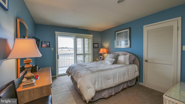 bedroom featuring access to exterior, carpet flooring, and baseboards