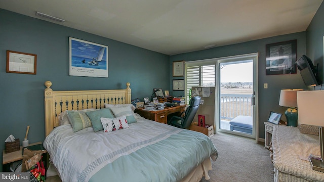 carpeted bedroom featuring access to exterior and visible vents