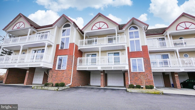 view of building exterior featuring an attached garage and driveway