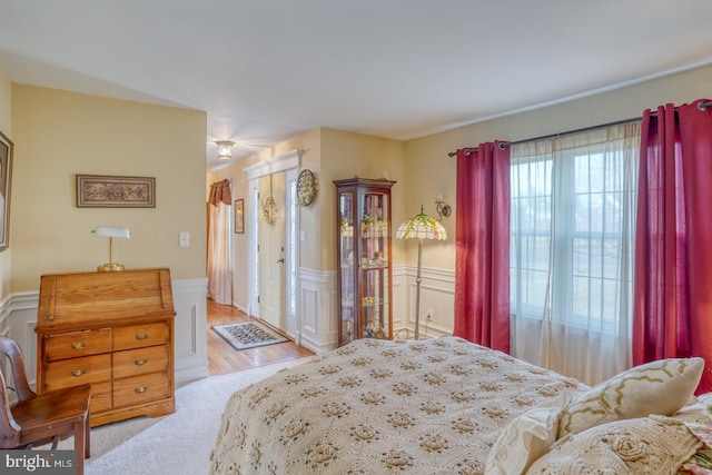 bedroom featuring a wainscoted wall