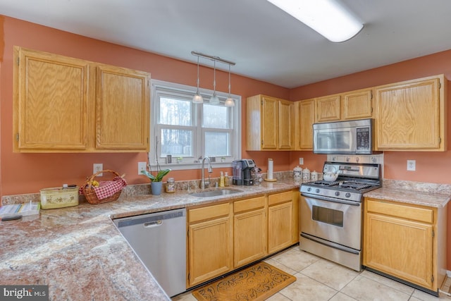 kitchen featuring light brown cabinetry, light countertops, light tile patterned flooring, stainless steel appliances, and a sink