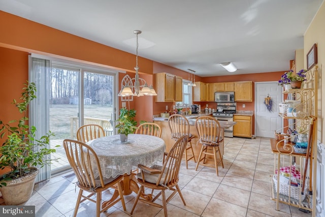 dining space with a notable chandelier and light tile patterned flooring