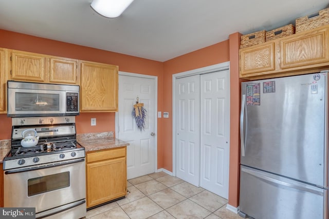 kitchen featuring light tile patterned floors and appliances with stainless steel finishes