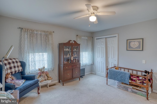 living area featuring visible vents, baseboards, carpet floors, and ceiling fan