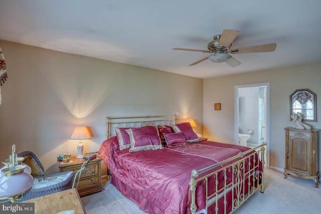 carpeted bedroom with connected bathroom, baseboards, and a ceiling fan