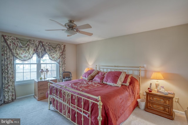 bedroom with baseboards, light carpet, and ceiling fan