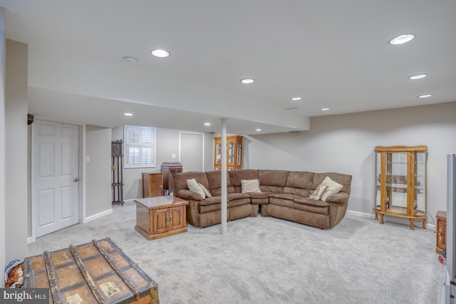 living room featuring recessed lighting, baseboards, and light carpet