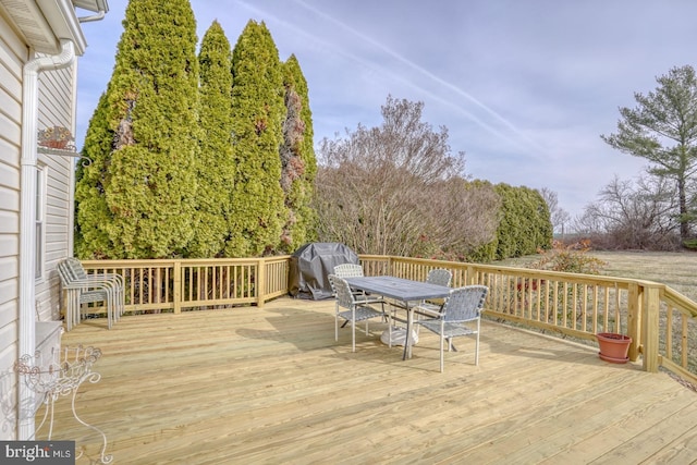 wooden deck with grilling area and outdoor dining area