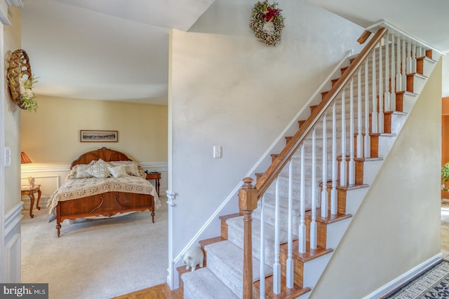 staircase with baseboards and carpet floors