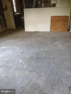 interior space featuring unfinished concrete flooring