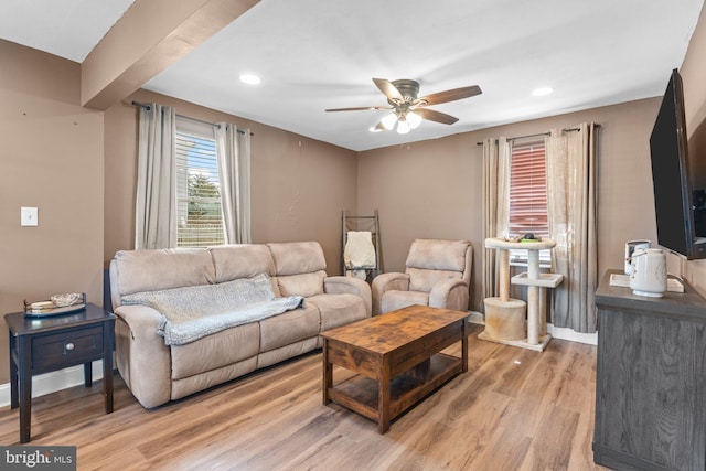 living room featuring recessed lighting, a ceiling fan, baseboards, and light wood finished floors