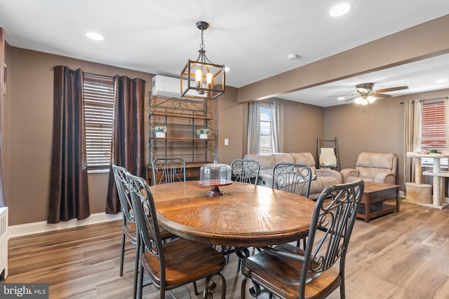 dining room featuring recessed lighting, ceiling fan with notable chandelier, light wood-type flooring, and baseboards