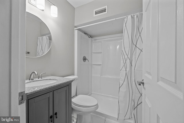 bathroom featuring vanity, toilet, a shower with curtain, and visible vents