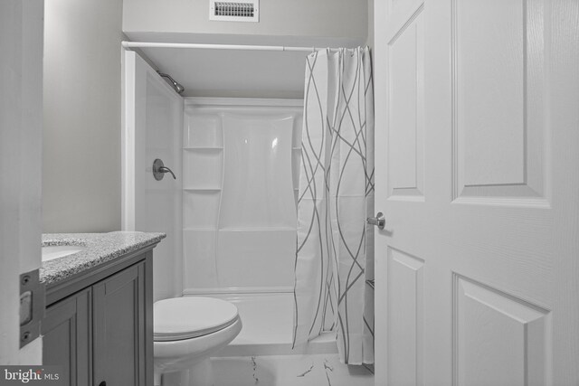 full bath with vanity, a shower stall, visible vents, and marble finish floor