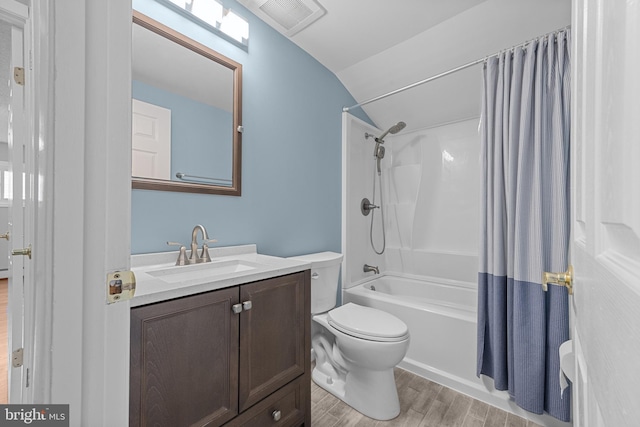 full bath featuring visible vents, toilet, shower / bath combo with shower curtain, wood finished floors, and vanity