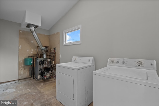 washroom with washer and dryer, laundry area, and a heating unit