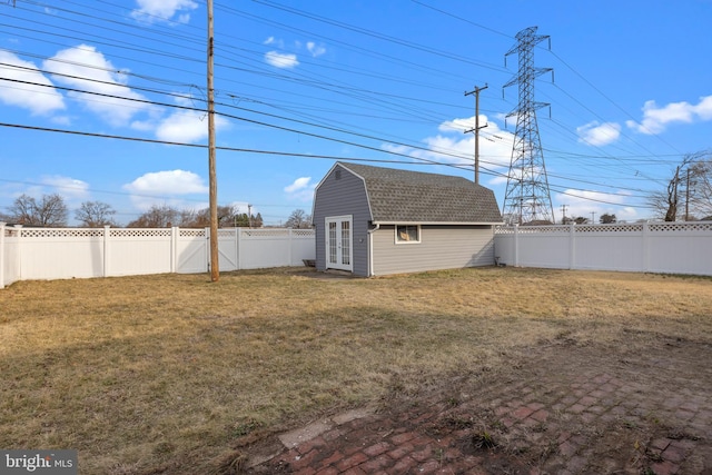 view of yard with an outdoor structure and a fenced backyard